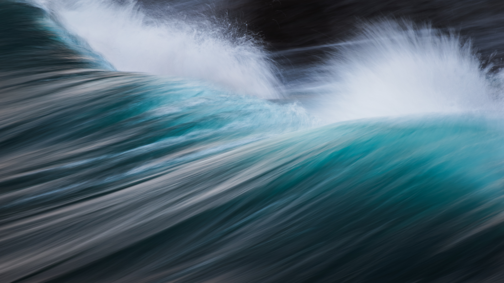 Teal wave cresting with white spray